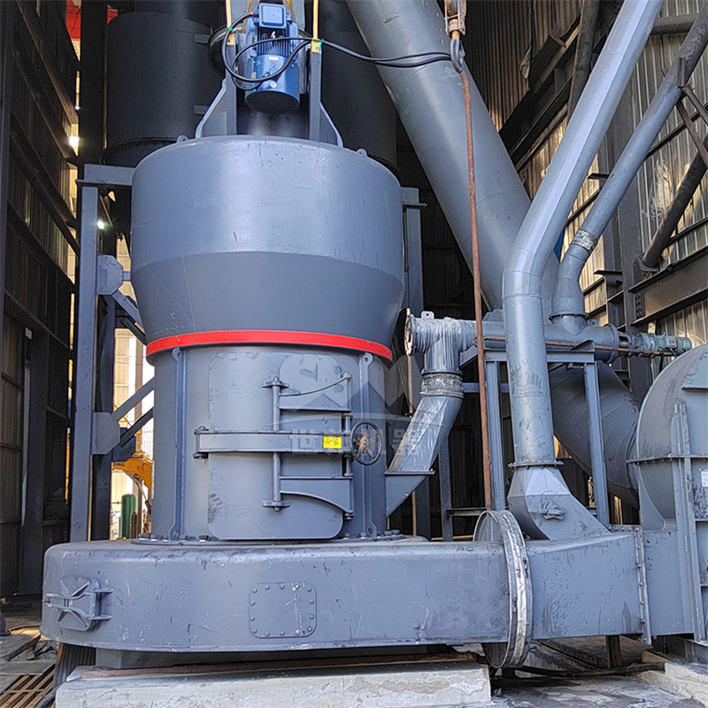Close-up view of an ultrafine grinding mill in operation with control panel